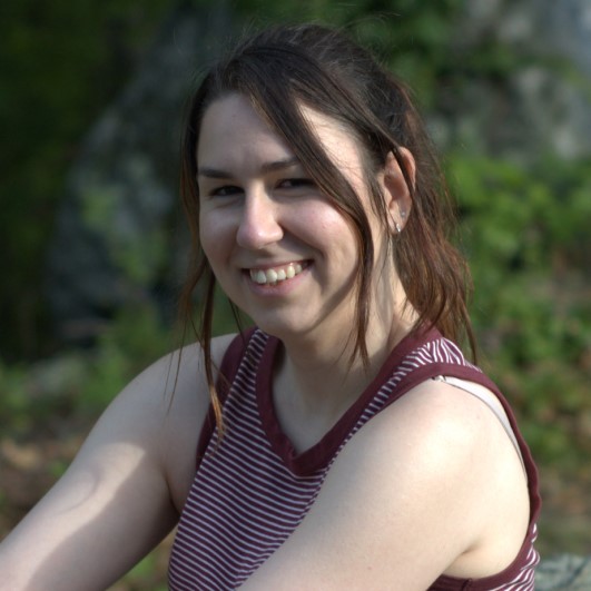 Profile picture of Rose with trees behind her.